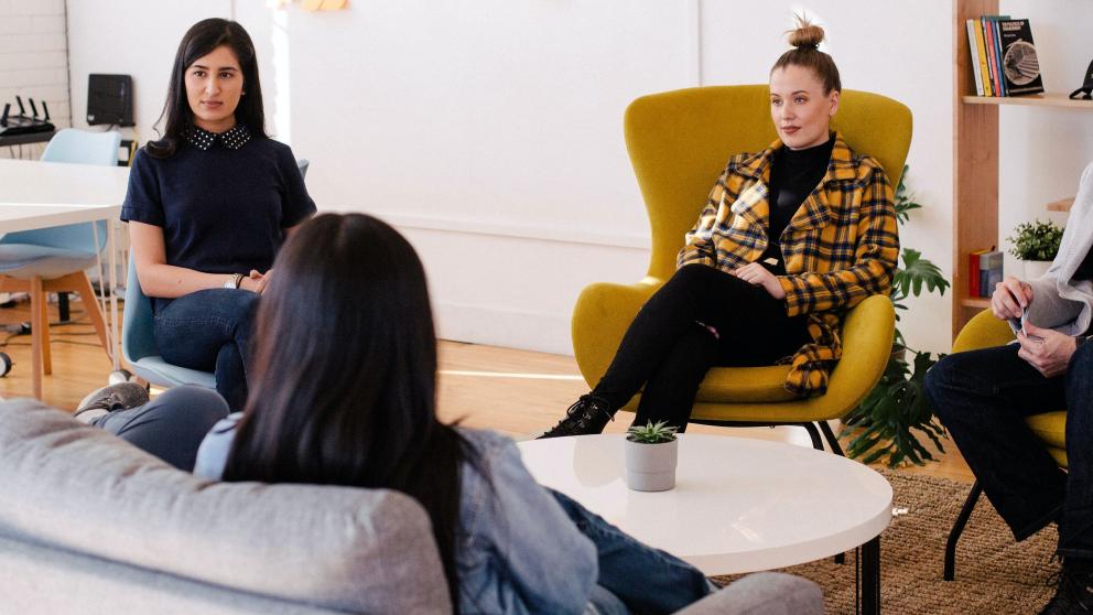 People working sitting on a couch