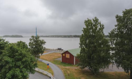 Maisemakuva Vaasan yliopiston kampukselta merta kohti pilvisenä kesäpäivänä.